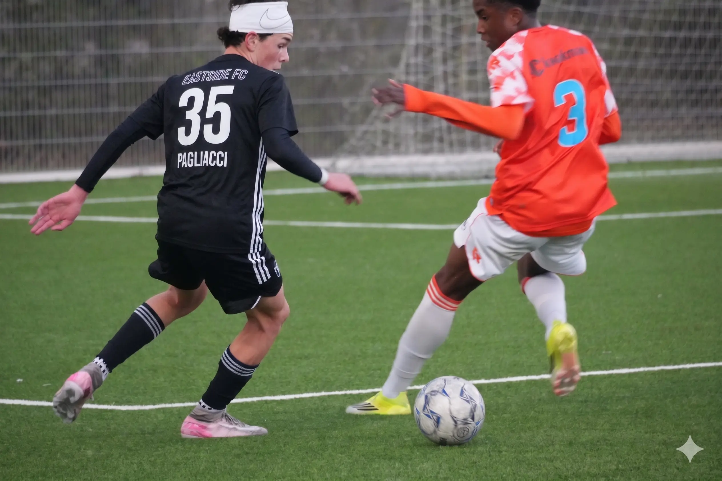 Daylen Hammon in black Real Colorado Datec kit with white Nike headband, focused on the ball vs Sparta Rotterdam player in red and white stripes at Rotterdam Orange Veins Tournament 2026